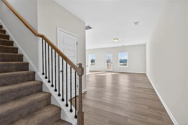 a view of an entryway with wooden floor