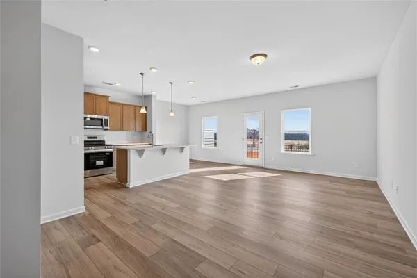 a view of kitchen with wooden floor and electronic appliances