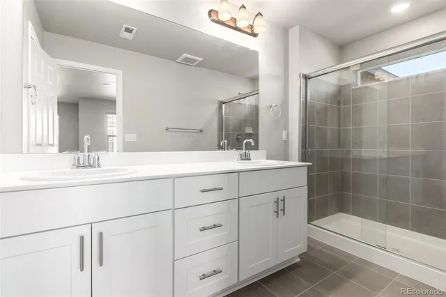 a bathroom with double sink and a mirror