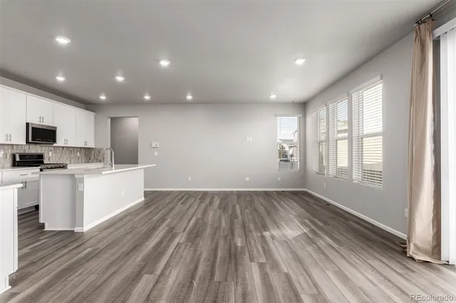 a view of kitchen with sink window and stainless steel appliances