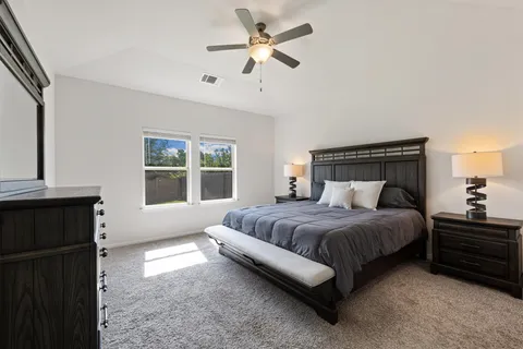 a bedroom with a bed dresser and a window
