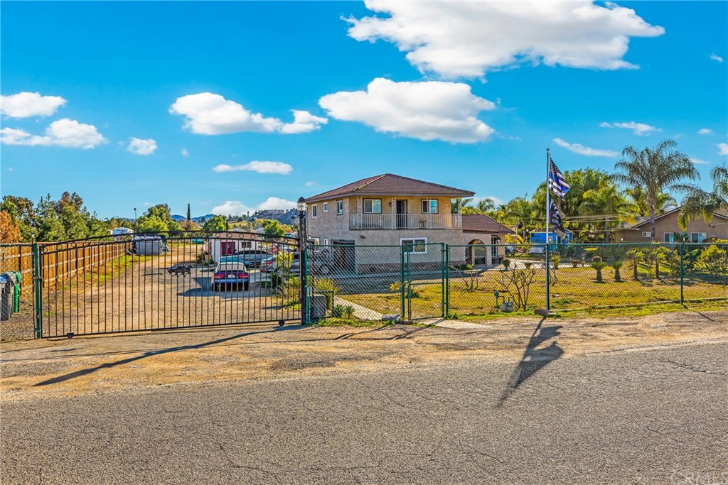 19915 Mariposa Avenue Riverside, CA 92508 - Photo 1 of 1 a view of a swimming pool with a lawn chairs under an umbrella