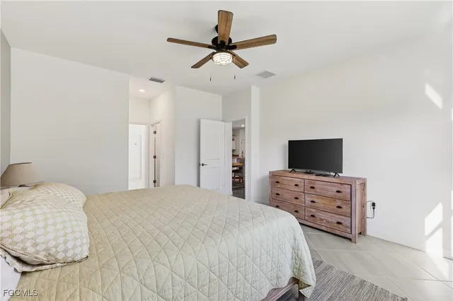 a bedroom with a bed and a television