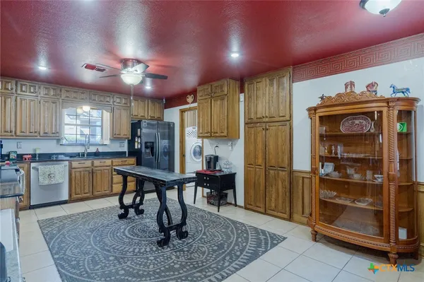 a kitchen with refrigerator and cabinets