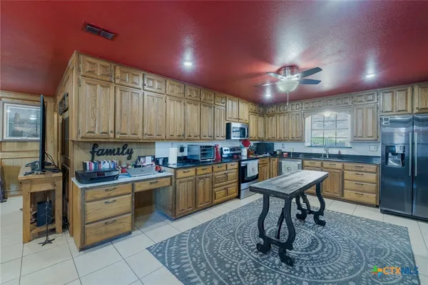 a kitchen with refrigerator and cabinets