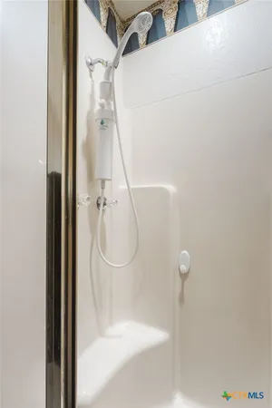 a bathroom with a glass shower door