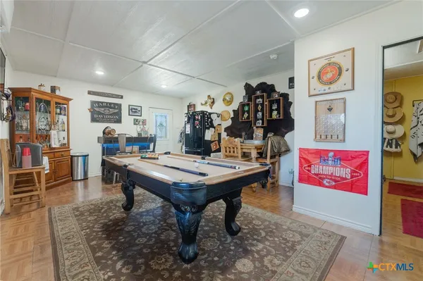 a room with furniture pool table and table soccer