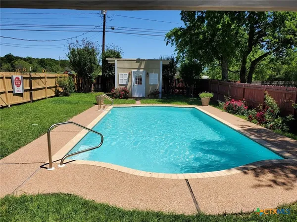 a view of a backyard with sitting area
