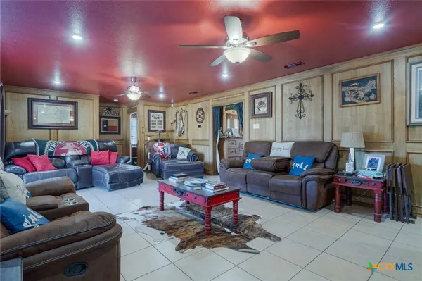 a living room with furniture and kitchen view