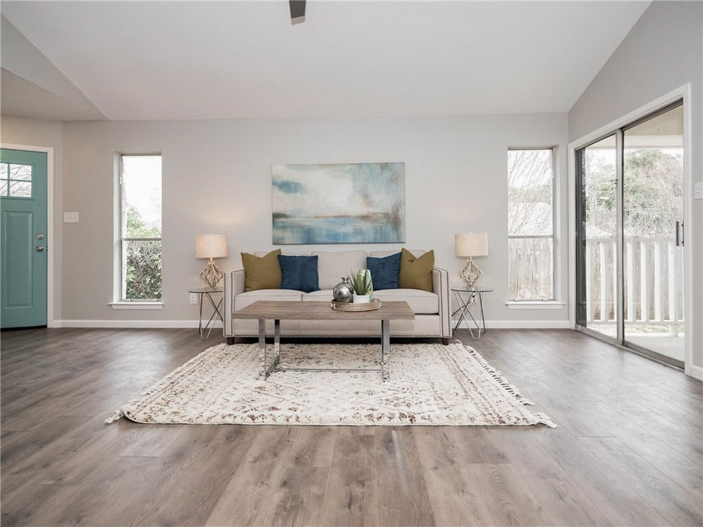 11118 Wandering Way Austin, TX 78754 - Photo 4 of 35 Unit A Living Room featuring vaulted ceiling and sliding door