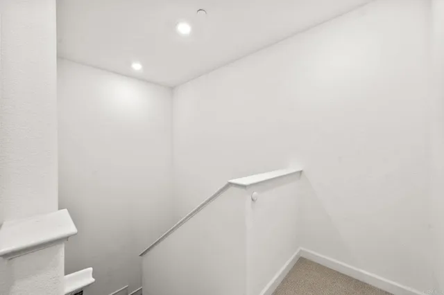 a bedroom with a large bed and teddy bear on bed