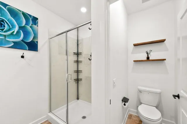 a front view of residential houses with yard and mountain view in back