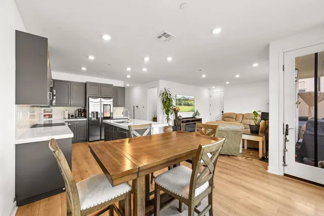 a kitchen with counter top space a sink stainless steel appliances and cabinets