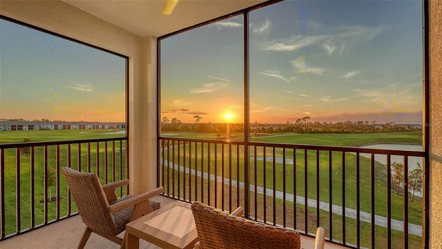 a view of a balcony with chair and wooden floor