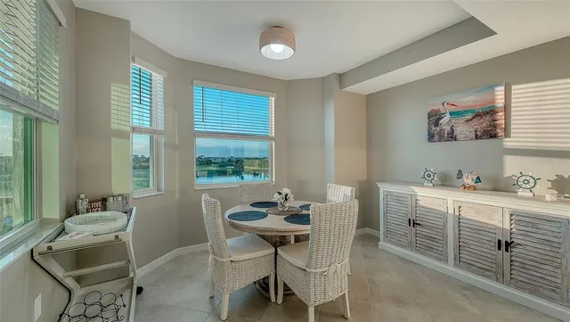 a kitchen with granite countertop white cabinets and stainless steel appliances