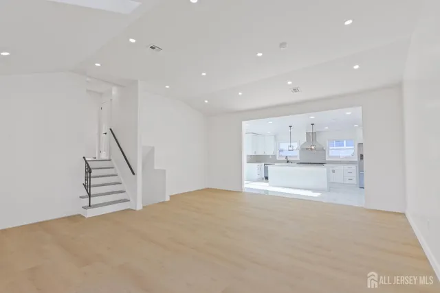 a view of a kitchen with wooden floor and stairs
