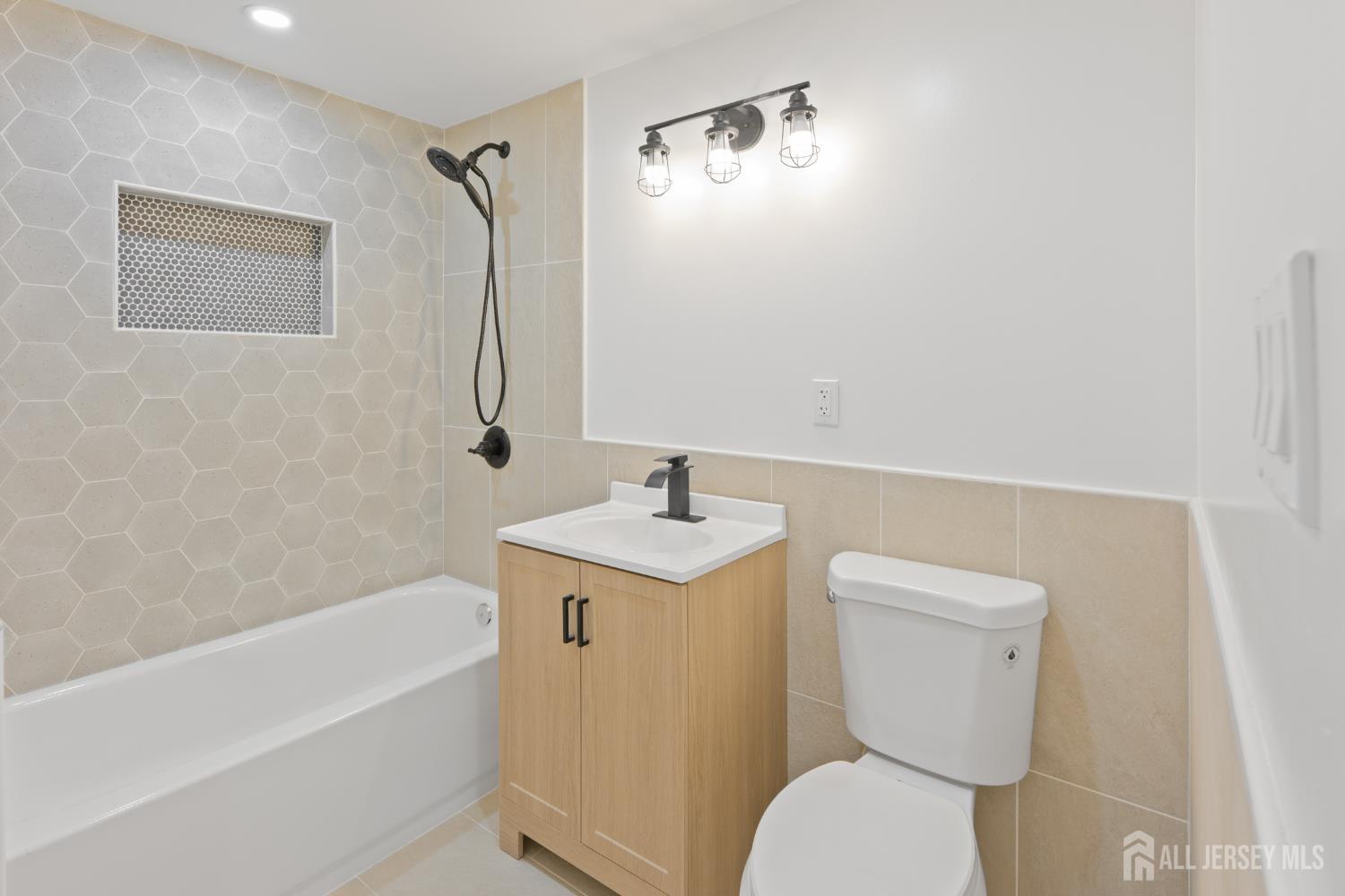 537 Ford Avenue Fords, NJ 08863 - Photo 14 of 35 a bathroom with a sink a toilet and shower