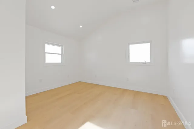 a view of a big room with closet and windows