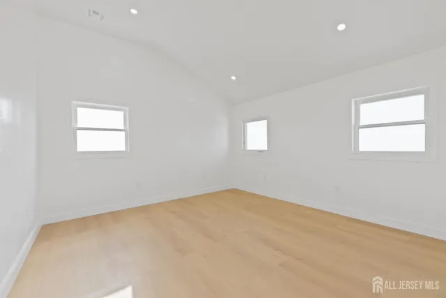 a view of a house with a wooden deck