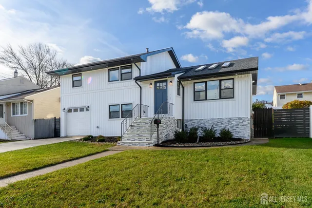 a front view of a house with a garden and plants