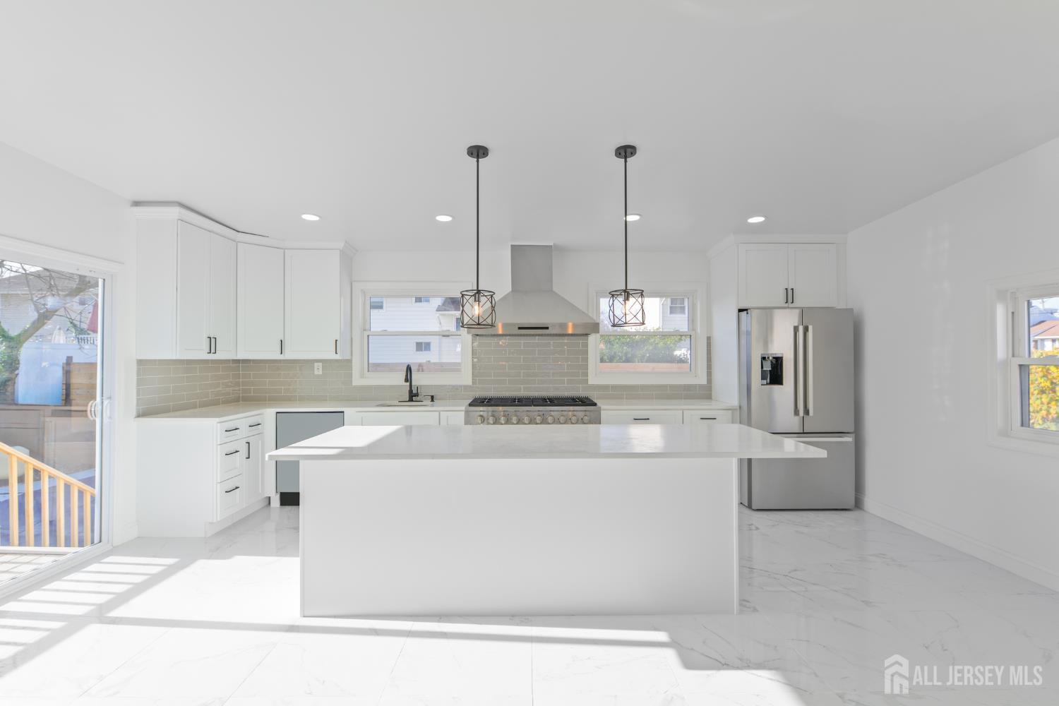 537 Ford Avenue Fords, NJ 08863 - Photo 7 of 35 a large white kitchen with stainless steel appliances