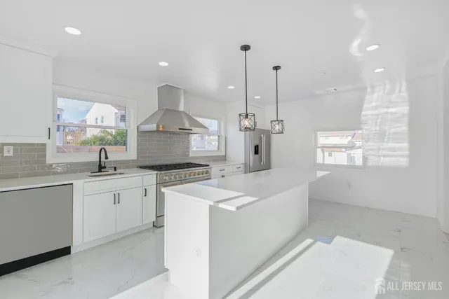 a large kitchen with kitchen island white cabinets and white appliances
