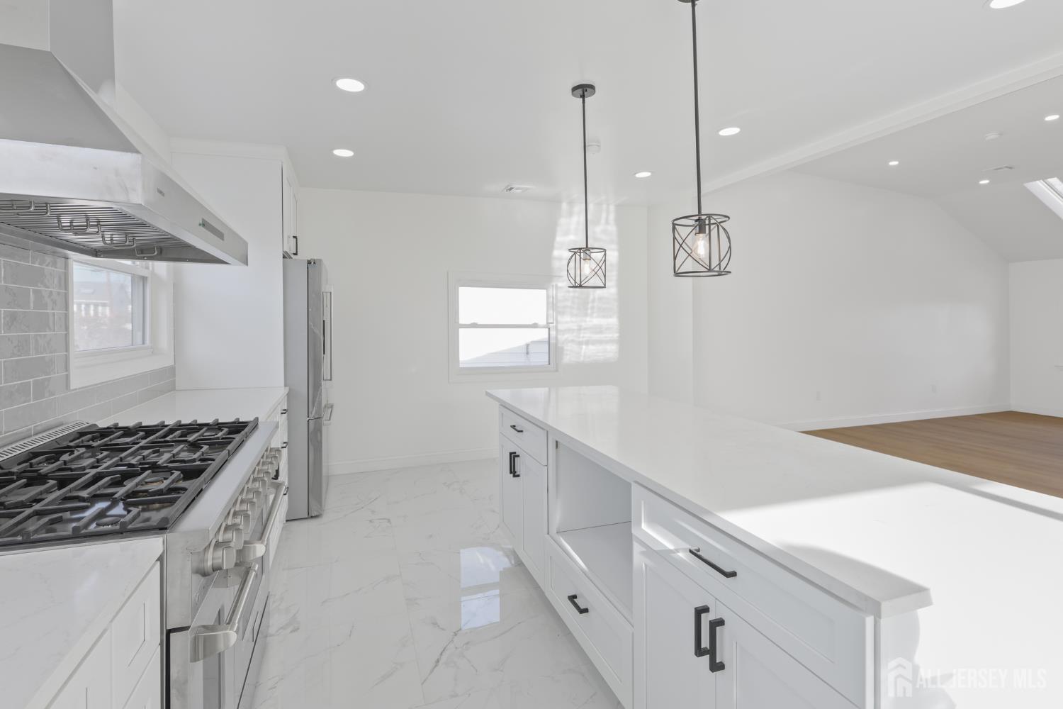 537 Ford Avenue Fords, NJ 08863 - Photo 9 of 35 a kitchen with white cabinets and stove
