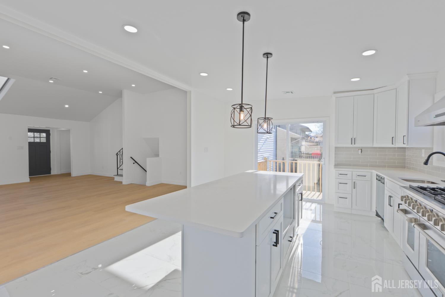537 Ford Avenue Fords, NJ 08863 - Photo 10 of 35 a kitchen with stainless steel appliances kitchen island granite countertop a sink a stove and a refrigerator