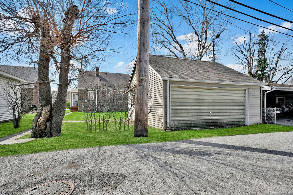 843 173rd Street Hammond, IN 46324 - Photo 18 of 18 a front view of a house with a yard and garage