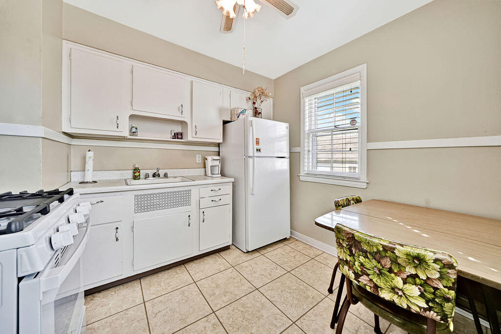 843 173rd Street Hammond, IN 46324 - Photo 6 of 18 a kitchen with a stove refrigerator and cabinets