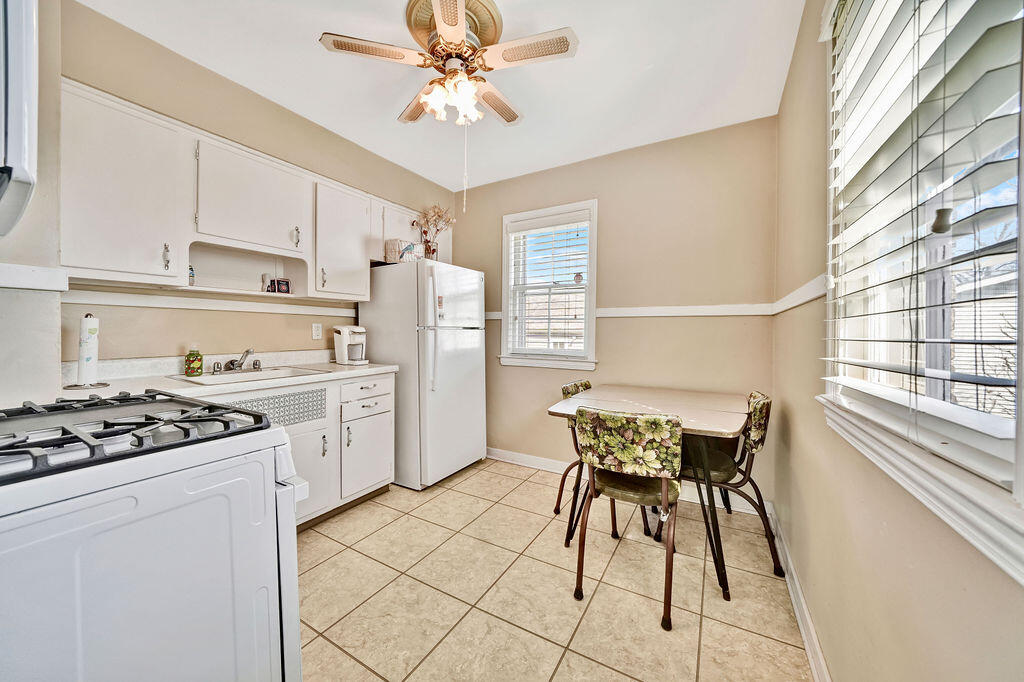 843 173rd Street Hammond, IN 46324 - Photo 7 of 18 a kitchen with stainless steel appliances a table and chairs in it