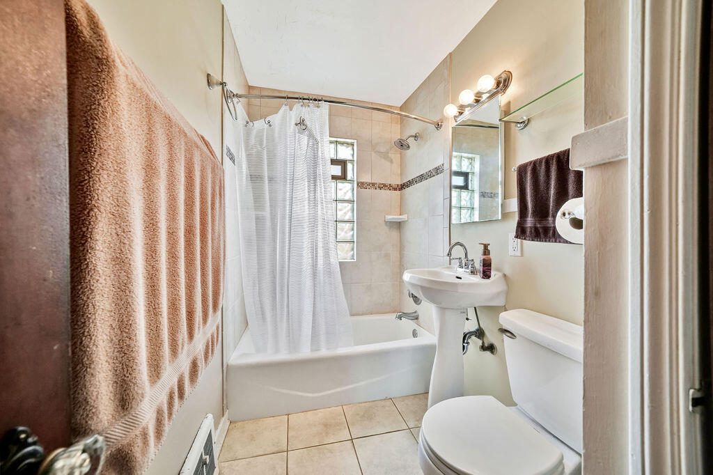 843 173rd Street Hammond, IN 46324 - Photo 10 of 18 a bathroom with a sink toilet and shower