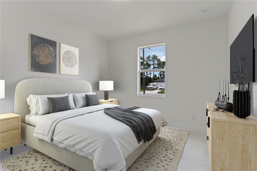 3513 15th Street Southwest Lehigh Acres, FL 33976 - Photo 20 of 22 a bedroom with a bed and a flat screen tv