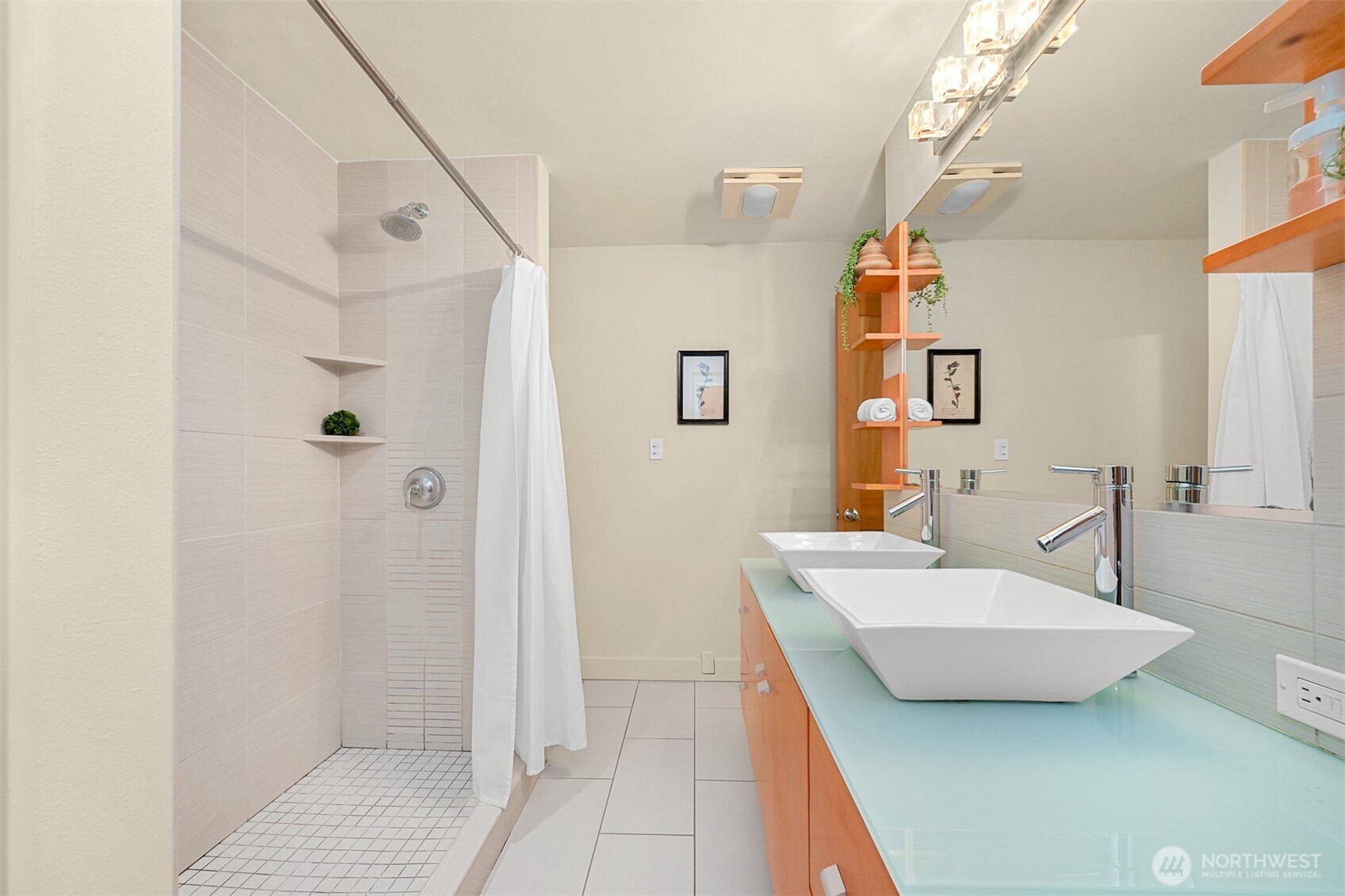 414 Boulevard, Unit 101 Bellingham, WA 98225 - Photo 12 of 32 a bathroom with a tub sink a mirror and shower