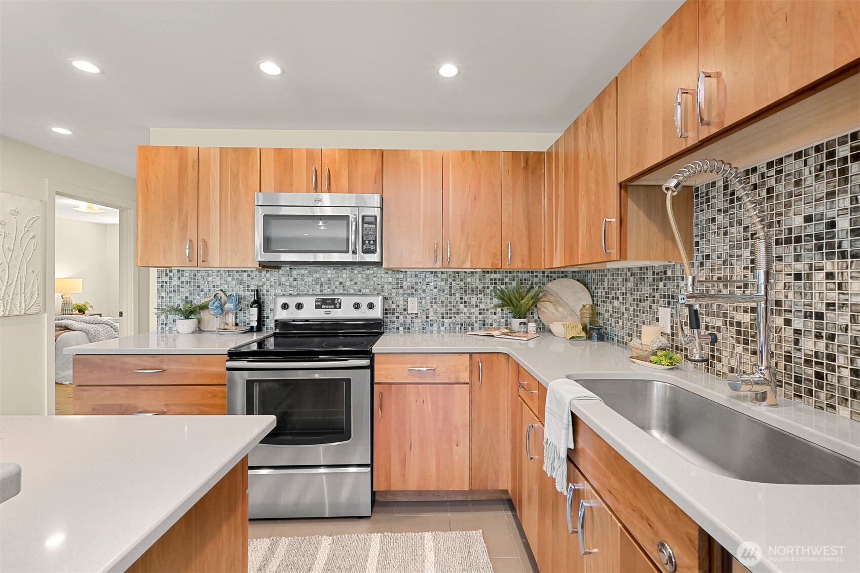 414 Boulevard, Unit 101 Bellingham, WA 98225 - Photo 7 of 32 a kitchen with granite countertop a sink and a stove top oven