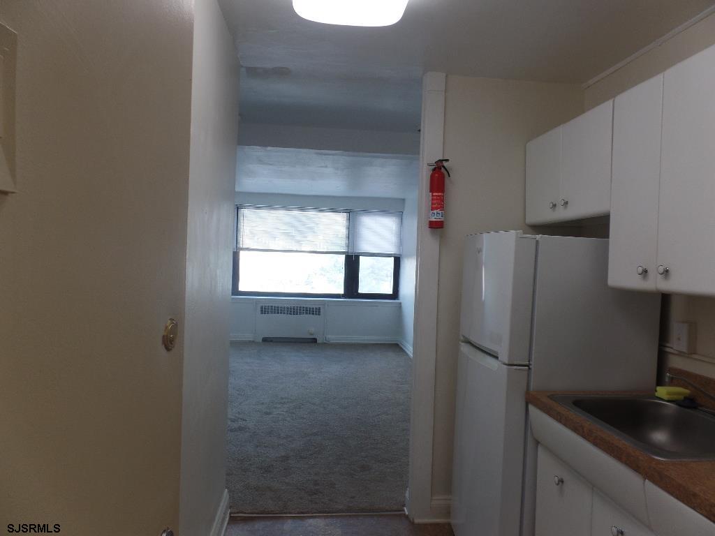 101 South Raleigh Avenue, Unit 221 Atlantic City, NJ 08401 - Photo 4 of 14 a kitchen with a refrigerator and window