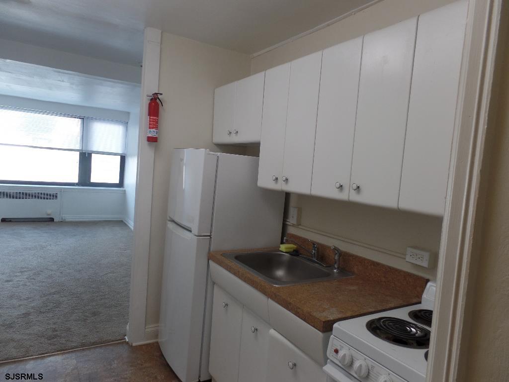 101 South Raleigh Avenue, Unit 221 Atlantic City, NJ 08401 - Photo 5 of 14 a kitchen with a sink and a refrigerator