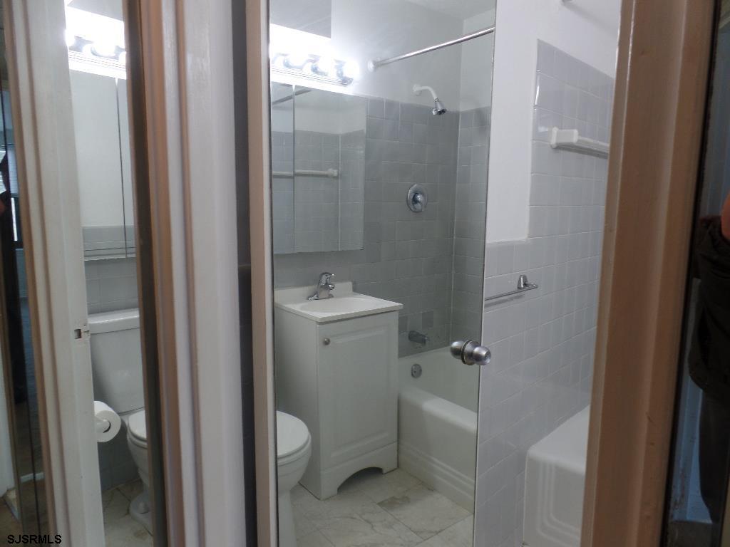 101 South Raleigh Avenue, Unit 221 Atlantic City, NJ 08401 - Photo 10 of 14 a bathroom with a granite countertop sink toilet and shower