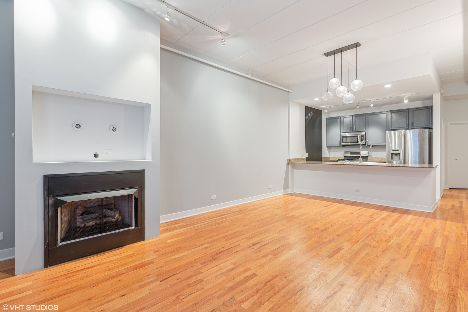 847 West Monroe Street, Unit 3A Chicago, IL 60607 - Photo 5 of 19 a view of a kitchen with a sink and a fireplace