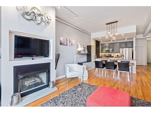 847 West Monroe Street, Unit 3A Chicago, IL 60607 - Photo 6 of 19 a living room with furniture a flat screen tv and a fireplace