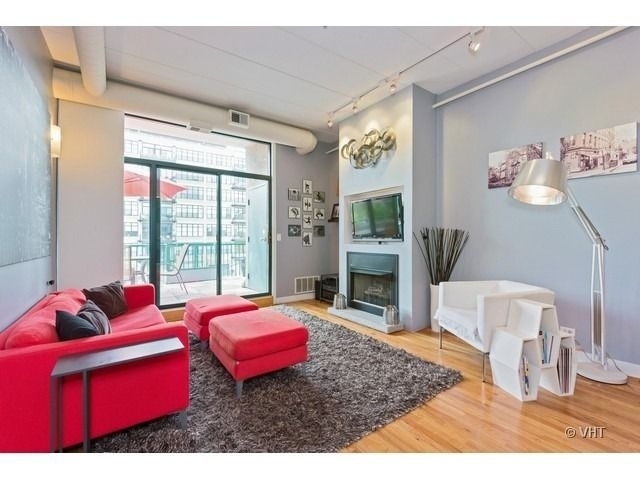 847 West Monroe Street, Unit 3A Chicago, IL 60607 - Photo 8 of 19 a living room with furniture a rug and a floor to ceiling window