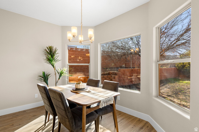 1570 South Rio Virgin Drive Washington, UT 84780 - Photo 21 of 71 Dining space featuring wood finished floors, a chandelier, and healthy amount of natural light