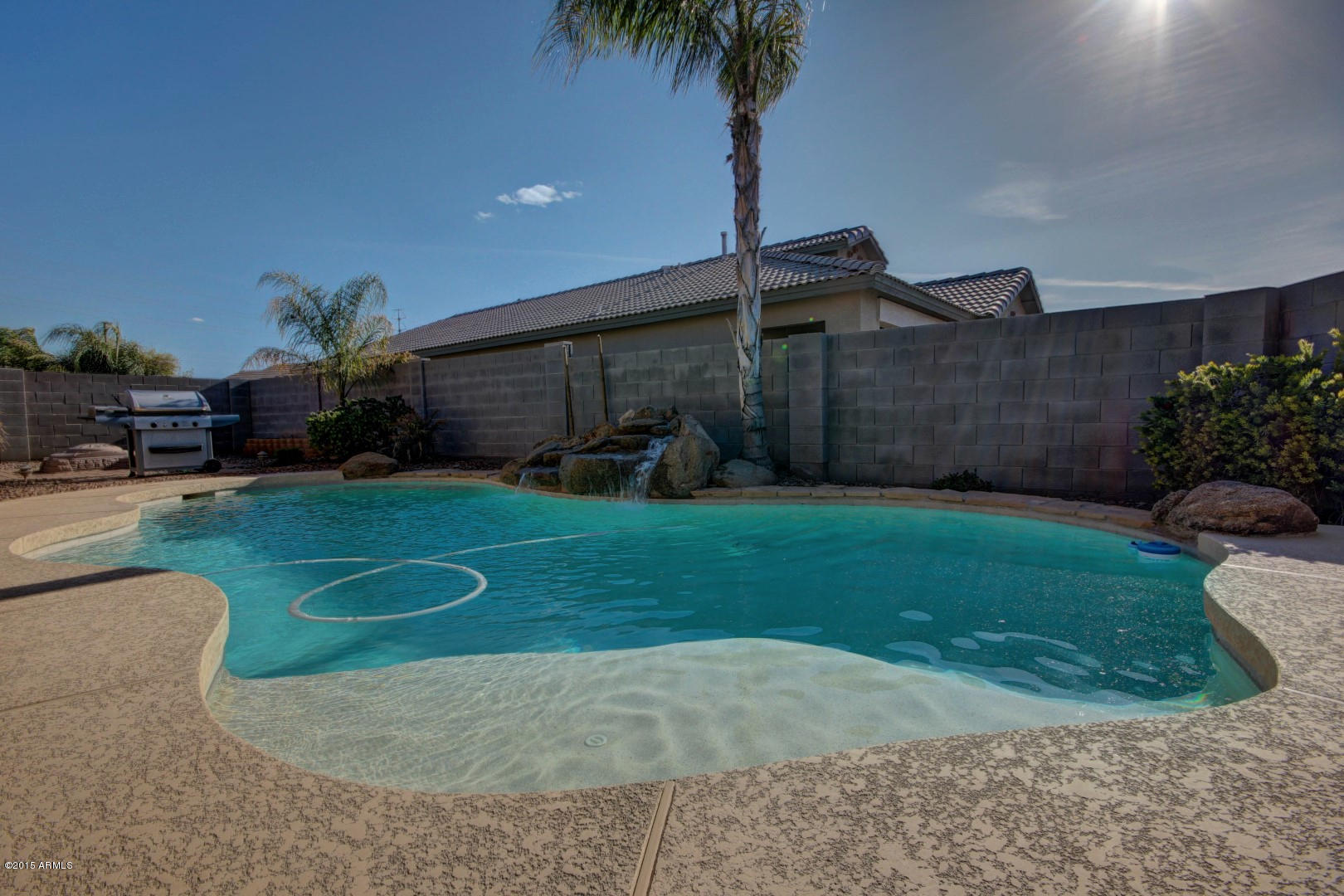 3534 South Sawmill Road Gilbert, AZ 85297 - Photo 23 of 25 Sparkling pool with waterfall feature