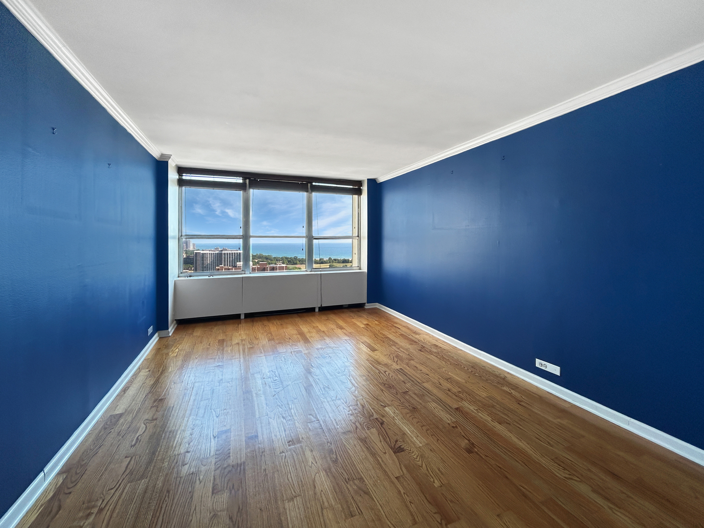 655 West Irving Park Road, Unit 3608 Chicago, IL 60613 - Photo 12 of 20 an empty room with wooden floor and windows