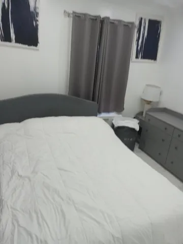 a bedroom with a bed and cabinets