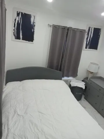 a bedroom with a bed and a television