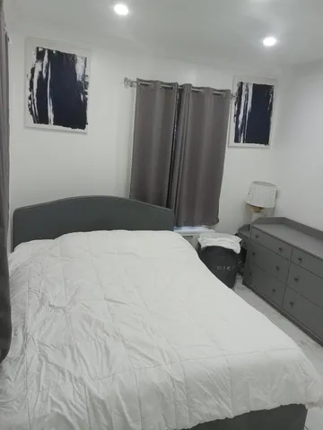 a bedroom with a bed and a television