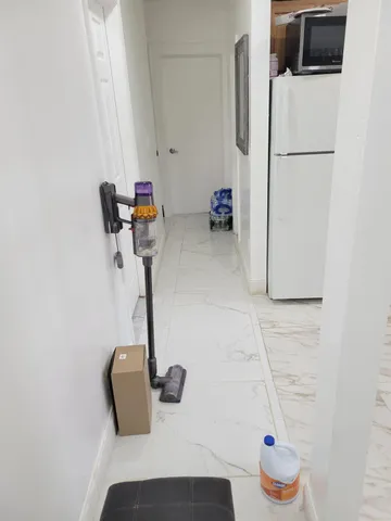 a kitchen with a refrigerator and a sink