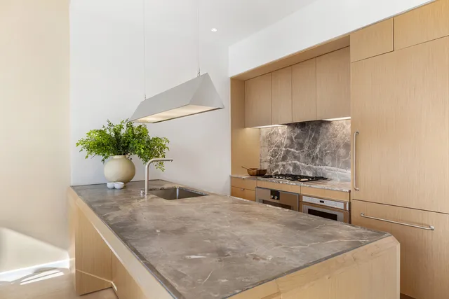 a living room with granite countertop furniture a flat screen tv and a large window