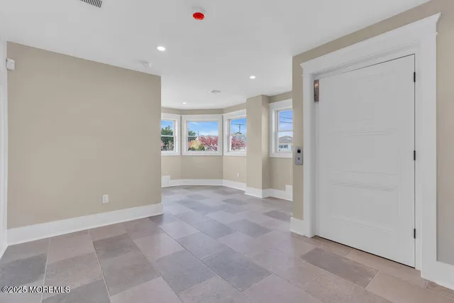 a view of a dining room with furniture a chandelier and wooden floor